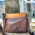 Fans Geek Store Dragon Ball messenger bag with Shenron design, brown faux leather and suede-effect flap, outdoor view