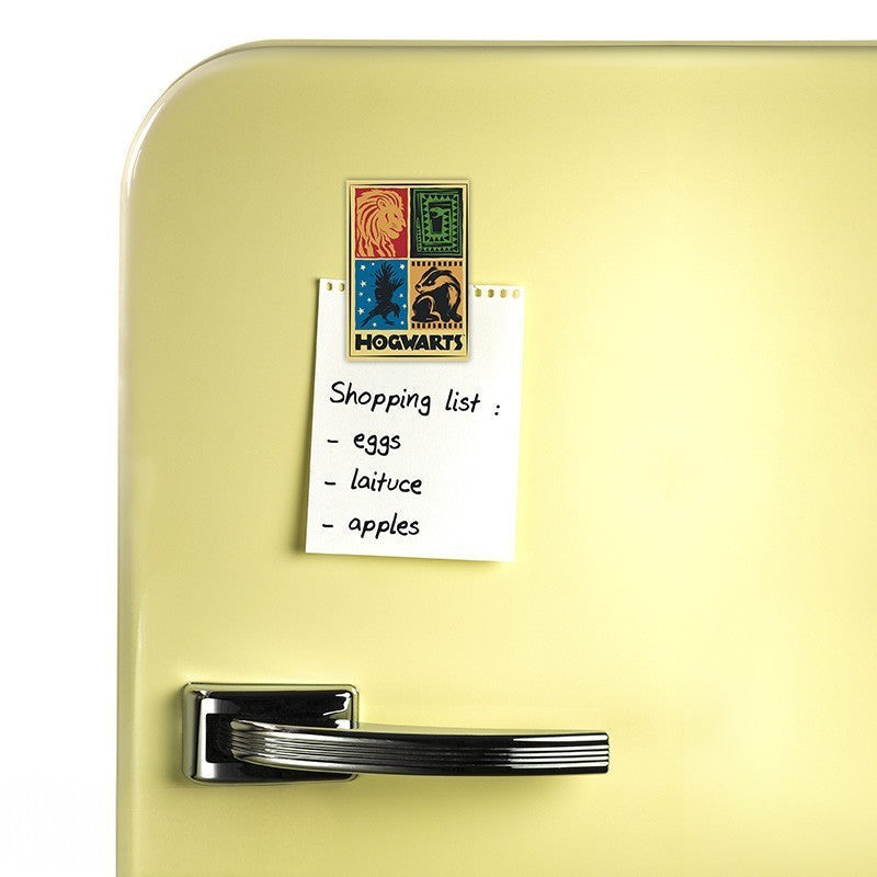 Fans Geek Store Harry Potter Hogwarts houses fridge magnet with matte finish holding a shopping list on a yellow fridge