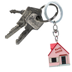 Fans Geek Store 3D Kame House keychain from Dragon Ball Z featuring a pink miniature house on a metal keyring