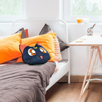 Fans Geek Store Luna cat decorative pillow from Sailor Moon with embroidered details on a bed with orange cushions
