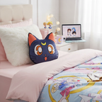 Fans Geek Store Sailor Moon Luna cat decorative pillow with embroidered details on a bed with anime bedding