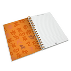 Fans Geek Store Naruto Shippuden A5 spiral notebook open to a lined page with orange Japanese character pattern