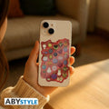 Fans Geek Store One Piece Devil Fruit vinyl sticker with glossy finish applied to the back of a smartphone