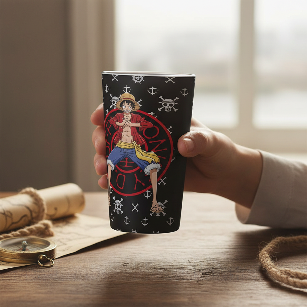 Fans Geek Store One Piece glass featuring Monkey D. Luffy with a black background and pirate motifs held in a hand
