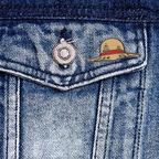 Fans Geek Store metal One Piece Luffy straw hat pin attached to a blue denim jacket pocket