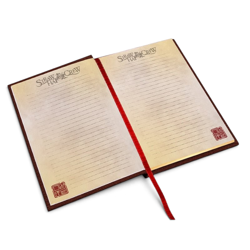 Fans Geek Store One Piece A5 notebook open with lined pages, Straw Crew branding, and a red ribbon bookmark.