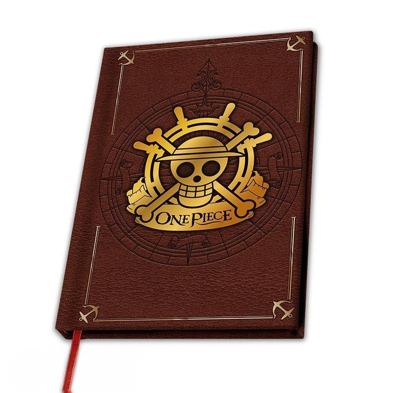 Fans Geek Store One Piece A5 notebook with brown textured cover, gold foil skull logo, and decorative anchor details.