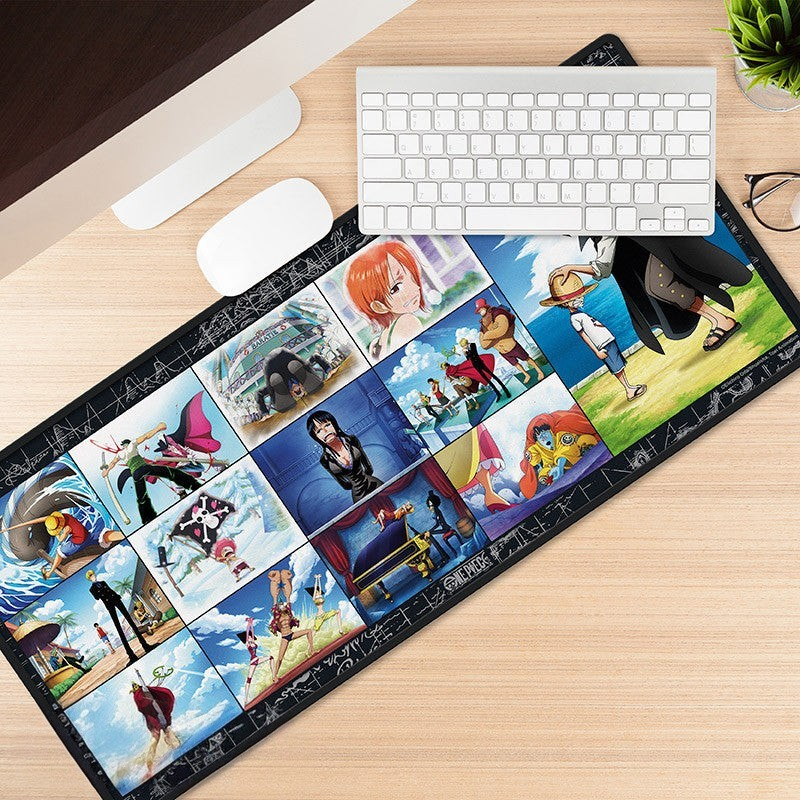 Fans Geek Store One Piece Straw Hat Crew XXL desk mat featuring anime character panels on a wooden desk setup