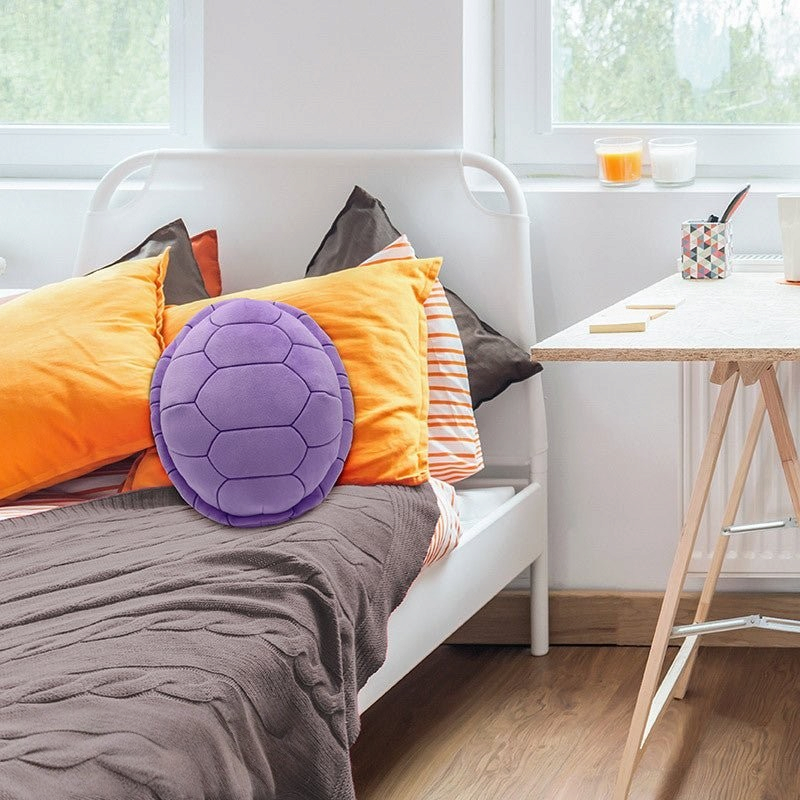 Fans Geek Store purple Dragon Ball Master Roshi turtle shell plush cushion on a bed with orange pillows