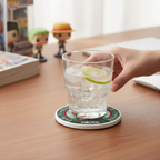Fans Geek Store ceramic One Piece Roronoa Zoro coaster with cork base under a glass of water on a wooden desk