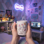 Fans Geek Store Sailor Moon ceramic mug featuring chibi Luna and Artemis in a cozy, themed bedroom setting.