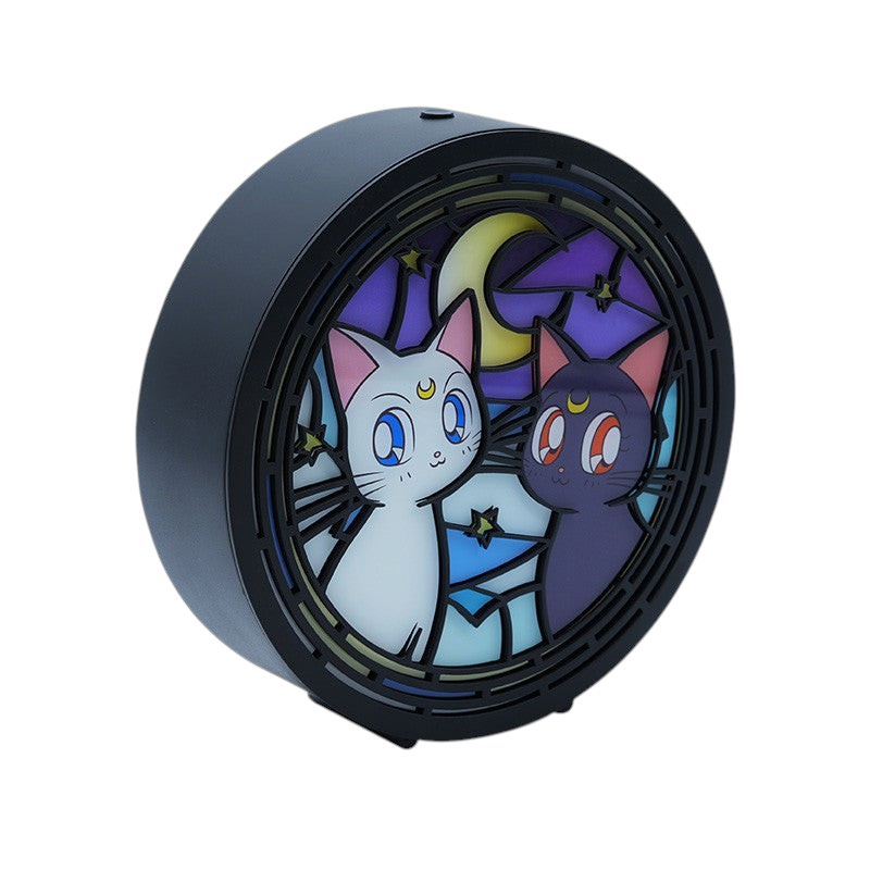 Fans Geek Store Sailor Moon LED lamp featuring Luna and Artemis in a round, stained-glass style design with warm light.