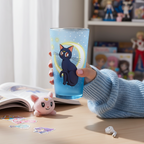 Fans Geek Store Sailor Moon glass featuring Luna cat design with a crescent moon, held by a person in a blue sweater.