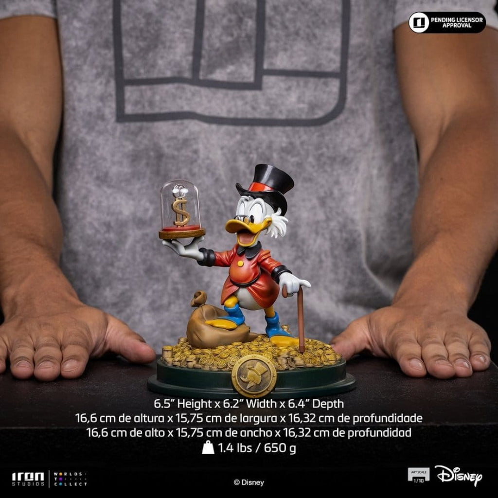 Iron Studios Duck Tales Art Scale Statue 1/10 Uncle Scrooge McDuck holding a dollar sign under glass, with a money bag and cane.