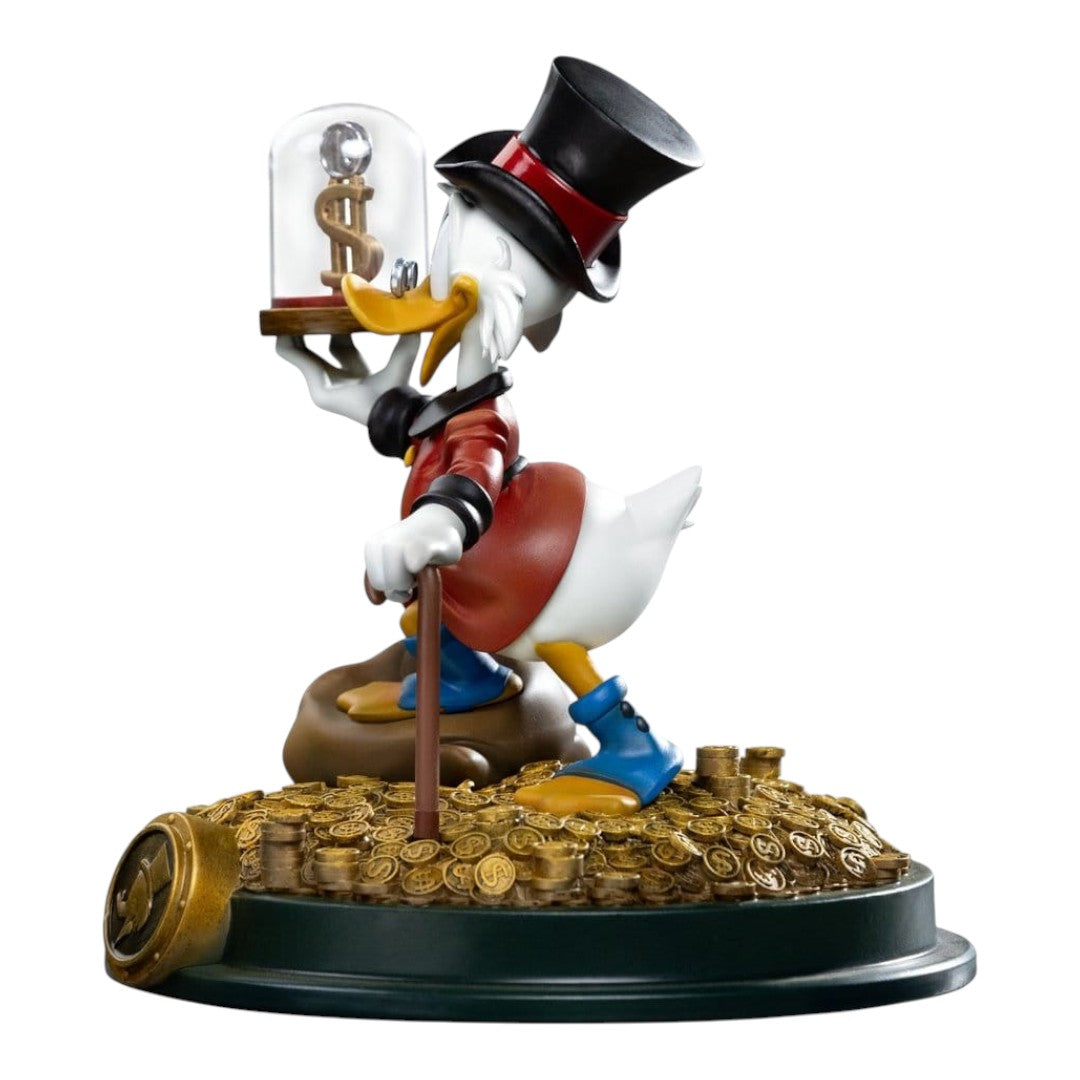 Iron Studios Uncle Scrooge McDuck statue, 17cm, hand-painted polystone, holding a dollar sign under glass, standing on gold coins.