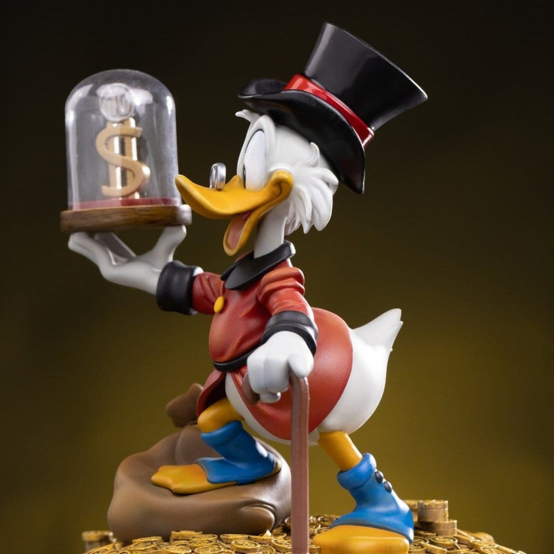 Iron Studios Uncle Scrooge McDuck statue, 17cm, hand-painted polystone, resin, ABS, PVC. Features iconic top hat, cane, and dollar sign.